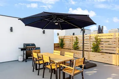 a table and chairs with an umbrella on a patio at Metro Loft LA in Los Angeles