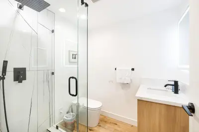 a bathroom with a shower and a toilet and a sink at Metro Loft LA in Los Angeles