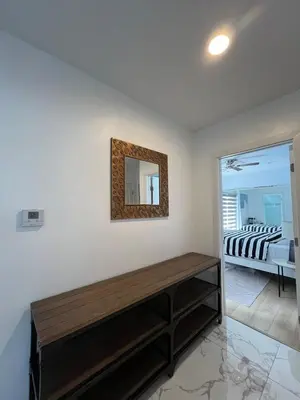 a living room with a mirror on the wall at Serene Luxe Residence near Rose Bowl in Pasadena
