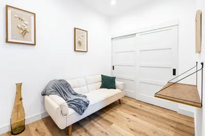 a white living room with a white couch at Sky Haus LA in Los Angeles