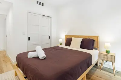 a bedroom with a large bed with a brown blanket at Sky Haus LA in Los Angeles