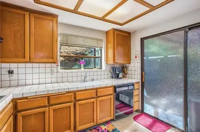 a kitchen with a sink and a glass shower at Pet friendly 3BR Spacious Home EV in Riverside
