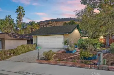 a house with a garage in a yard at Pet friendly 3BR Spacious Home EV in Riverside