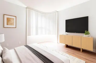 a white bedroom with a large bed and a television at 1BR Apartment in Marina del Rey - Near Venice Beach, Pool, Gym, Sauna, Hot Tub, EV Charging in Los Angeles