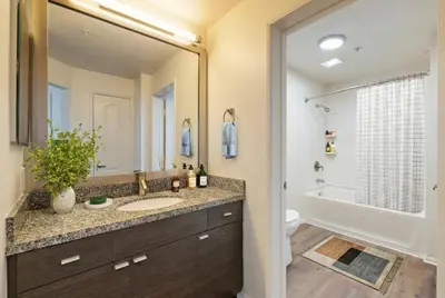 a bathroom with a sink and a toilet and a mirror at Marina Del Rey Apartment with Resort Amenities - Short Distance To Venice Beach in Los Angeles