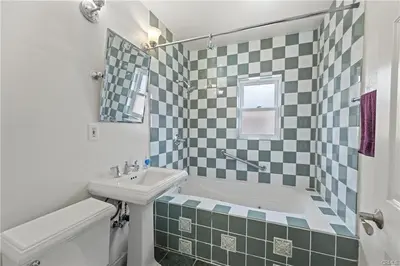 a bathroom with a sink and a tub and a toilet and a bath tub at 4 bedrooms in Long Beach