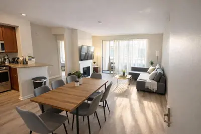 a living room with a table and chairs and a kitchen at Marina Del Rey 2BR & 1BR Getaway - Gym - Pool - Sauna - Near Marina - Venice Beach in Los Angeles