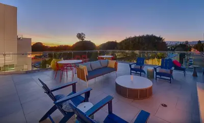 a patio with chairs and tables on a balcony at Santa Monica 3BD Serenity Suite with FREE PARKING in Los Angeles