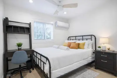 a bedroom with a bed and a desk and a chair at Modern 3BR Home Near USC, Museums & Coliseum in Los Angeles