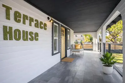 a front porch of a house with a sign that reads terrace house at Modern 3BR Home Near USC, Museums & Coliseum in Los Angeles