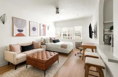 a living room with a couch and a table at Beverly Grove Hotel in Los Angeles