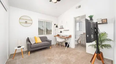 a living room with a couch and a tv at Heidi House Entire Duplex Relocation Stays in Redlands