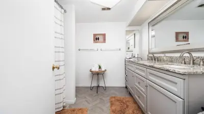 a bathroom with two sinks and a shower at Heidi House Entire Duplex Relocation Stays in Redlands