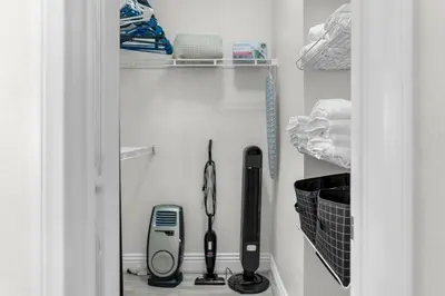 a closet with a hair dryer and other items at Pool Hot Tub King Bed 1st Floor Condo in Corona