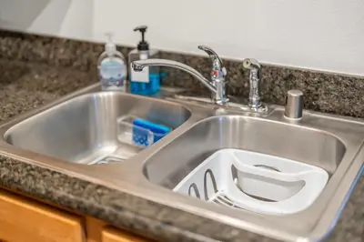 a stainless steel sink with a drain in it at Pool Hot Tub King Bed 1st Floor Condo in Corona