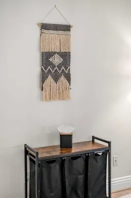 a table with a rug hanging on a wall at Pool Hot Tub King Bed 1st Floor Condo in Corona