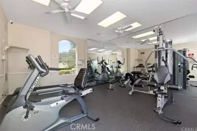 a gym with several treadmills and cardio machines at Pool Hot Tub King Bed 1st Floor Condo in Corona