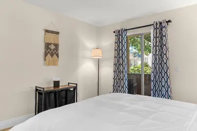 a bedroom with a large bed and a window at Pool Hot Tub King Bed 1st Floor Condo in Corona