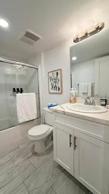 a bathroom with a toilet and a sink and a mirror at Modern Luxury House 3B&4B House 30 mins DTLA in Baldwin Park