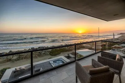 a view of the ocean at sunset from a house at Rincon Refuge - Beachfront for 6 in Ventura