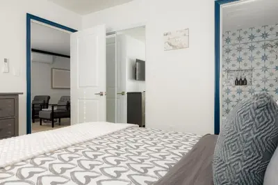 a bedroom with a bed and a living room at Pet-Friendly 2BR-2BA Near SoFi-Small Dogs Welcome in Los Angeles