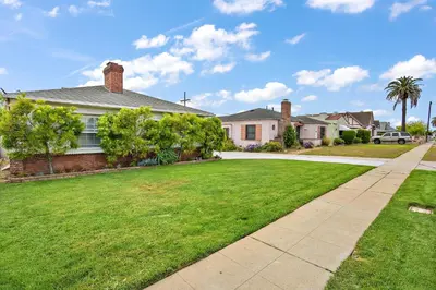 a house with a green lawn and a sidewalk at The SOFI Special - Modern Retreat, Dog Friendly in Los Angeles