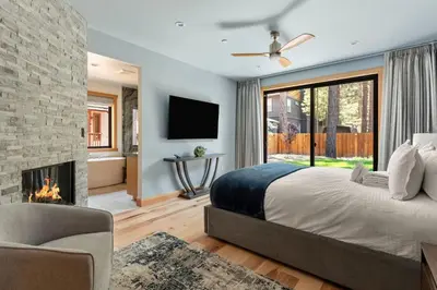 a bedroom with a large bed and a fireplace at 34 - The Maple Crest home in Big Bear Lake