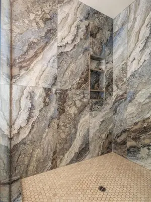 a bathroom with a large stone wall at 34 - The Maple Crest home in Big Bear Lake