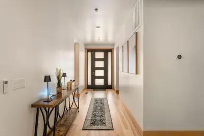 a hallway with a door and a rug at 34 - The Maple Crest home in Big Bear Lake