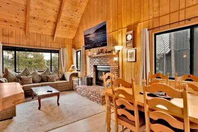 a living room with a couch and a fireplace at Lakeview Pines Log Cabin #2585 in Big Bear Lake