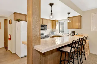 a kitchen with a white refrigerator and a counter at Summit Ski and Bike Trails #2574 in Big Bear Lake