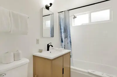 a white bathroom with a sink and a mirror at Slope Side Getaway #2526 in Big Bear Lake