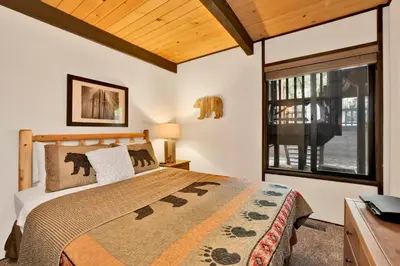 a bedroom with a bed and a window at Switzerland Summit Condo #2569 in Big Bear Lake