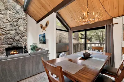 a dining room with a table and a fireplace at Switzerland Summit Condo #2569 in Big Bear Lake