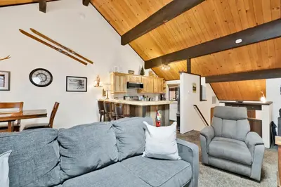a living room with a blue couch and chairs at Switzerland Summit Condo #2569 in Big Bear Lake