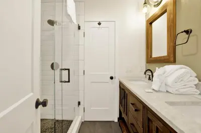 a bathroom with a shower and a sink and a mirror at Arlberg Village Haus #2571 in Big Bear Lake