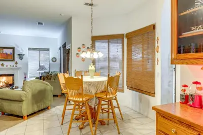 a kitchen and living room with a table and chairs at 5 Mi to the Marketplace Roomy Bakersfield Retreat in Bakersfield