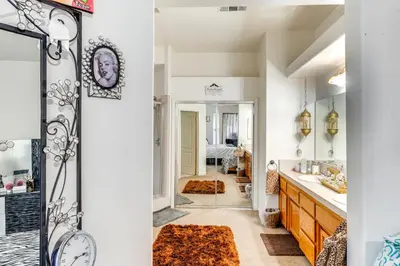a bathroom with a sink and a mirror at 5 Mi to the Marketplace Roomy Bakersfield Retreat in Bakersfield