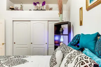 a bedroom with a bed with blue and white pillows at 5 Mi to the Marketplace Roomy Bakersfield Retreat in Bakersfield