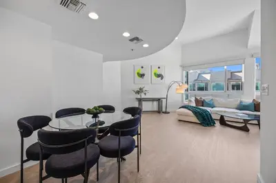 a living room with a table and chairs and a couch at Waterfront Penthouse - Marina Views - Rooftop in Los Angeles