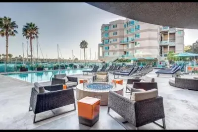 a resort patio with chairs and a swimming pool at Waterfront Penthouse - Marina Views - Rooftop in Los Angeles