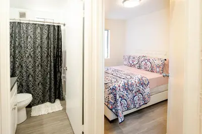 a small bedroom with a bed and a toilet at Cozy 2 Bedroom In Hollwood area Close to Downtown La in Los Angeles