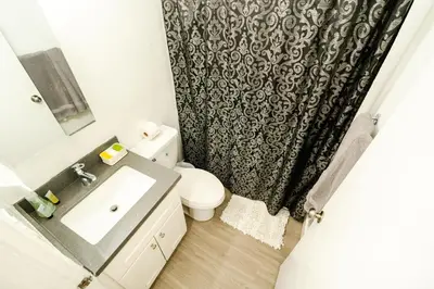 a bathroom with a sink and a toilet and a shower curtain at Cozy 2 Bedroom In Hollwood area Close to Downtown La in Los Angeles