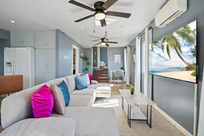 a living room with a couch and a ceiling fan at Darling 2 bedroom 1 bathroom Highland Park Home with Jacuzzi and View in Los Angeles