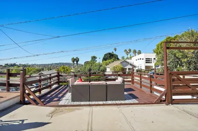 a patio with a couch and a table on a fence at Darling 2 bedroom 1 bathroom Highland Park Home with Jacuzzi and View in Los Angeles