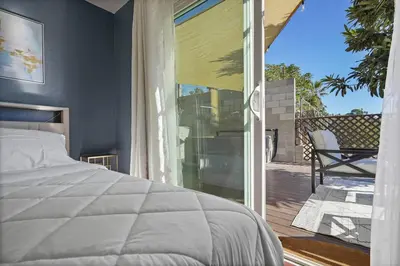 a bedroom with a bed and a sliding glass door at Darling 2 bedroom 1 bathroom Highland Park Home with Jacuzzi and View in Los Angeles