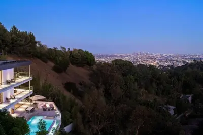 a house on a hill with a view of a city at Stunning Hollywood Villa Pool and Panoramic Views in Los Angeles
