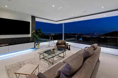 a living room with a couch and a tv at Stunning Hollywood Villa Pool and Panoramic Views in Los Angeles