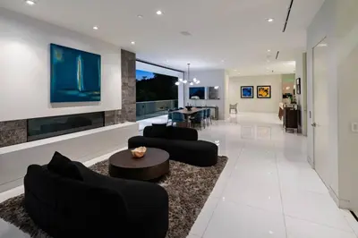 a living room with two couches and a table at Stunning Hollywood Villa Pool and Panoramic Views in Los Angeles