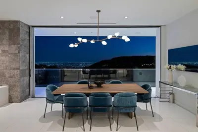 a dining room with a table and chairs and a large window at Stunning Hollywood Villa Pool and Panoramic Views in Los Angeles
